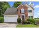 Well-maintained two-story home with brick and siding, featuring an attached garage and landscaped front yard at 4305 Chesapeake Trce, Acworth, GA 30101