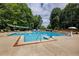 Large community pool with lounge chairs, umbrellas, and lush landscaping, perfect for relaxation at 4305 Chesapeake Trce, Acworth, GA 30101