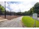 Community tennis courts, walking path, and well-maintained landscaping under a blue sky with scattered clouds at 4305 Chesapeake Trce, Acworth, GA 30101