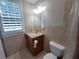 Bathroom featuring a vanity, mirror, tiled walls, and a window at 45 Mountain Crest Dr, Oxford, GA 30054