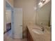 Bathroom featuring a granite countertop, wood cabinets, and views into other bathroom areas at 45 Mountain Crest Dr, Oxford, GA 30054