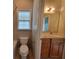Well-lit bathroom featuring a shower-tub combo and a vanity with modern fixtures at 45 Mountain Crest Dr, Oxford, GA 30054