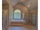 Sunlit bathroom boasts a luxurious soaking tub next to a window and glass enclosed shower, creating a spa-like experience at 45 Mountain Crest Dr, Oxford, GA 30054