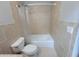 Bathroom featuring a combination shower and bathtub with light tan tiling at 45 Mountain Crest Dr, Oxford, GA 30054