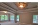 Primary bedroom features a tray ceiling, large windows, and fan at 45 Mountain Crest Dr, Oxford, GA 30054