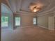 Primary bedroom features a tray ceiling, large windows, and fan at 45 Mountain Crest Dr, Oxford, GA 30054
