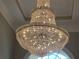 A stunning, multi-tiered crystal chandelier enhances the grand foyer's elegance at 45 Mountain Crest Dr, Oxford, GA 30054
