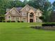 Stunning two-story brick home with arched windows and a meticulously manicured lawn at 45 Mountain Crest Dr, Oxford, GA 30054