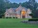 Elegant brick two-story home with a manicured lawn, mature trees, and a grand entrance with a striking chandelier at 45 Mountain Crest Dr, Oxford, GA 30054