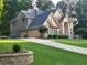 Stunning two-story home featuring a lush green lawn, brick exterior, and attached two-car garage at 45 Mountain Crest Dr, Oxford, GA 30054