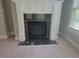 Close-up of fireplace with black marble and elegant white mantel, adding a touch of style to the living space at 45 Mountain Crest Dr, Oxford, GA 30054