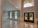 Grand foyer featuring high ceilings, marble flooring, custom iron doors, and arched windows at 45 Mountain Crest Dr, Oxford, GA 30054