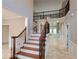 Elegant staircase in the entry foyer with hardwood treads and ornamental iron railings at 45 Mountain Crest Dr, Oxford, GA 30054