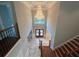 Grand foyer with a soaring chandelier, marble floors, and a decorative wrought iron front door at 45 Mountain Crest Dr, Oxford, GA 30054