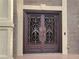 Elaborate wrought iron double front door in a brick home with cream-colored trim at 45 Mountain Crest Dr, Oxford, GA 30054
