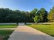 View of the front yard showcasing lush landscaping, lawn, and the driveway at 45 Mountain Crest Dr, Oxford, GA 30054