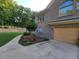 Side view of the house showing the garage, brick exterior, and landscaped grounds at 45 Mountain Crest Dr, Oxford, GA 30054