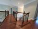 Elegant hallway with hardwood floors and decorative wrought iron banister details at 45 Mountain Crest Dr, Oxford, GA 30054