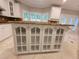 Kitchen island features glass cabinetry and granite countertop with seating at 45 Mountain Crest Dr, Oxford, GA 30054