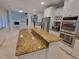Open-concept kitchen boasts granite counters, stainless appliances, and white cabinetry at 45 Mountain Crest Dr, Oxford, GA 30054