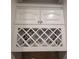 Custom white cabinetry with decorative lattice wine rack at 45 Mountain Crest Dr, Oxford, GA 30054