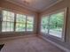Sun-filled living room features a fireplace and plenty of windows offering a view of the private, wooded surroundings at 45 Mountain Crest Dr, Oxford, GA 30054
