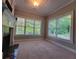 Bright living room boasts a fireplace and lots of natural light from large windows overlooking a green outdoor view at 45 Mountain Crest Dr, Oxford, GA 30054