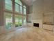 Spacious living room with tall windows, fireplace, built-in shelving, and tile floors at 45 Mountain Crest Dr, Oxford, GA 30054