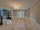 Living room featuring beautiful light fixture, windows with custom shutters, and marble floors at 45 Mountain Crest Dr, Oxford, GA 30054
