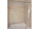 Shower-tub combo with neutral tile surround and a shower curtain rod at 45 Mountain Crest Dr, Oxford, GA 30054