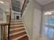 Staircase with wood treads, white risers, and dark wood banister at 45 Mountain Crest Dr, Oxford, GA 30054