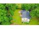 Aerial view of a home with a large backyard, mature trees, and a driveway at 5293 Sandy Shoals Ln, Stone Mountain, GA 30087