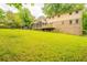 Spacious backyard with a screened porch, wooden deck, and mature landscaping surrounding the property at 5293 Sandy Shoals Ln, Stone Mountain, GA 30087