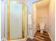 Bright bathroom with gold framed shower and toilet at 5293 Sandy Shoals Ln, Stone Mountain, GA 30087