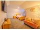 Bedroom featuring a bed with side tables, couch, and large TV at 5293 Sandy Shoals Ln, Stone Mountain, GA 30087