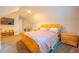 Bedroom featuring a bed with side tables, shelves, electric fireplace, and large TV at 5293 Sandy Shoals Ln, Stone Mountain, GA 30087