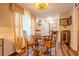 Cozy dining area featuring a round table with ornate chairs, warm lighting, and wood-look flooring at 5293 Sandy Shoals Ln, Stone Mountain, GA 30087