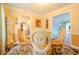 Dining room featuring a round glass table, ornate chairs, adjacent to kitchen and living area at 5293 Sandy Shoals Ln, Stone Mountain, GA 30087