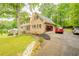 Two story home with brick and siding, black shutters, front yard landscaping, and an attached 2-car garage at 5293 Sandy Shoals Ln, Stone Mountain, GA 30087