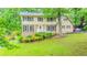 Charming two-story home featuring brick and vinyl siding, well-kept lawn, and mature trees at 5293 Sandy Shoals Ln, Stone Mountain, GA 30087