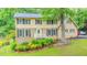 Charming two-story home featuring brick and vinyl siding, well-kept lawn, and mature trees at 5293 Sandy Shoals Ln, Stone Mountain, GA 30087