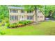 Charming two-story home featuring brick and vinyl siding, well-kept lawn, and mature trees at 5293 Sandy Shoals Ln, Stone Mountain, GA 30087