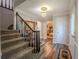 Inviting foyer features wood floors, a staircase, and an elegant chandelier at 5293 Sandy Shoals Ln, Stone Mountain, GA 30087
