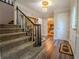 Inviting foyer features wood floors, a staircase, and an elegant chandelier at 5293 Sandy Shoals Ln, Stone Mountain, GA 30087