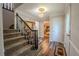 Inviting foyer features wood floors, a staircase, and an elegant chandelier at 5293 Sandy Shoals Ln, Stone Mountain, GA 30087