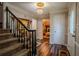 Inviting foyer features wood floors, a staircase, and an elegant chandelier at 5293 Sandy Shoals Ln, Stone Mountain, GA 30087