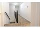 Hallway with carpet flooring and dark railing, providing access to the upper level of the home at 5293 Sandy Shoals Ln, Stone Mountain, GA 30087
