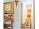 Hallway featuring neutral walls, white trim, an area rug, and access to the kitchen at 5293 Sandy Shoals Ln, Stone Mountain, GA 30087