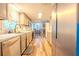 Galley kitchen featuring modern appliances, light gray cabinets, and hardwood floors at 5293 Sandy Shoals Ln, Stone Mountain, GA 30087