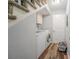Laundry area with washer, dryer, under-stair storage, and adjacent unfinished space at 5293 Sandy Shoals Ln, Stone Mountain, GA 30087